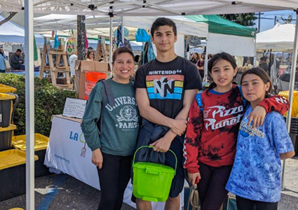 A family brings their kitchen food scraps to the Atwater Village Farmers’ Market Food Scrap Drop-off location in Northeast Los Angeles. LA Compost currently hosts drop-off locations at 11 Los Angeles farmers’ markets, with more to come soon! 