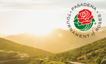 A road winds through Southern California mountains with the sun setting over the scene. The Pasadena Tournament of Roses logo is superimposed over the top right of the image.
