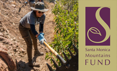 Worker in dark pants and shirt wearing a sun hat, using a fire rake. The left side of the image features a reddish dirt trail. The right side features green shrubs and the Santa Monica Mountains Fund Logo.