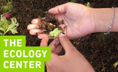 A picture of hands holding soil, mixed with lettuce, a worm in the soil. Behind the hand is the soil of a compost bin, and the logo for the Ecology Center is branded over the photo in the bottom left.