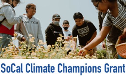 A group of children leaning over a field of yellow flowers. One girl in the foreground leans over and is picking at a bloom, a basket in her other hand. Below the photo is the logo for the SoCal Climate Champions Grant.